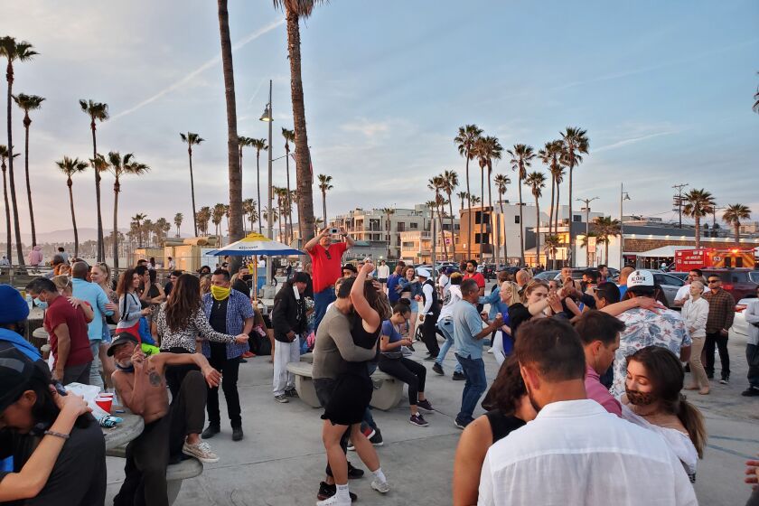 Approaching a new dance floor is always intimidating. Here, Angelenos dance to salsa and bachata near the Venice Pier as Covid-19 figures continue to drop and restrictions ease.