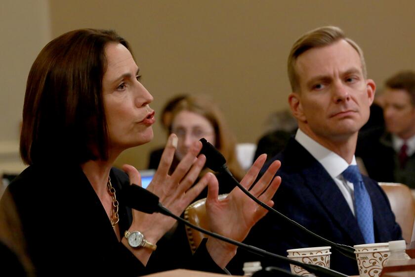 WASHINGTON, DC, NOVEMBER 21, 2019: Dr. Fiona Hill, the former top Russia and Europe expert on the National Security Council, and David Holmes, an official from the American embassy in Ukraine who overheard the call between Mr. Sondland and Mr. Trump testifies during the open hearing of the House Intelligence Committee into the impeachment inquiry of President Donald Trump. (Kirk McKoy / Los Angeles Times)