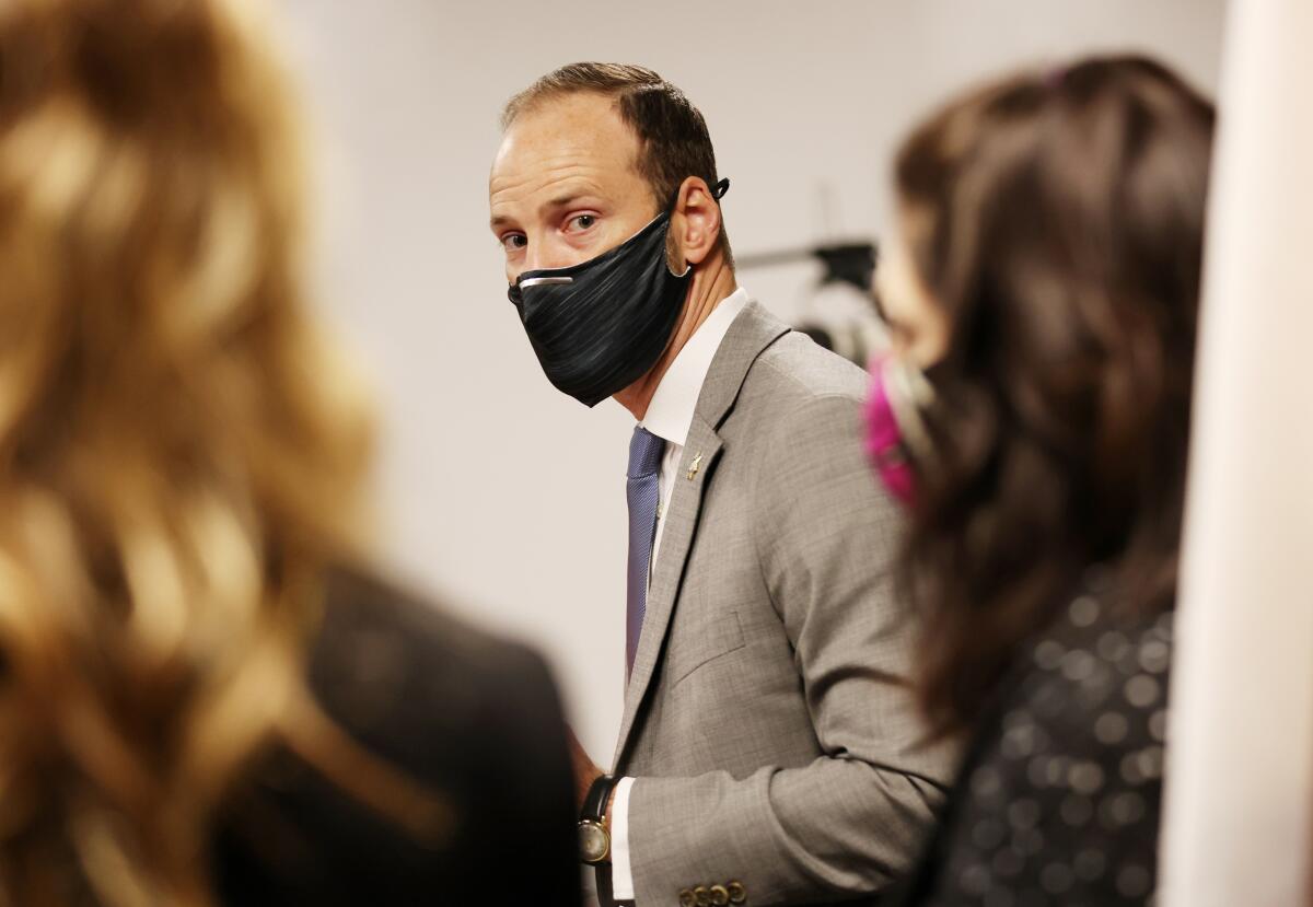 San Francisco District Attorney Chesa Boudin in a suit and a mask