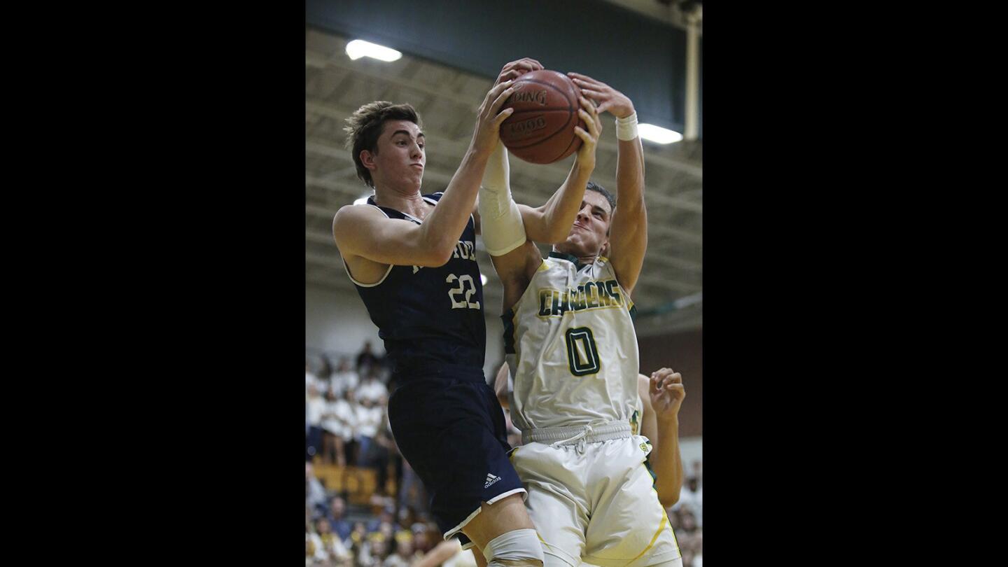 Edison's David Atencio battles for a rebound with Newport Harbor's Jake Bashore during a Sunset League game on Friday, January 12.