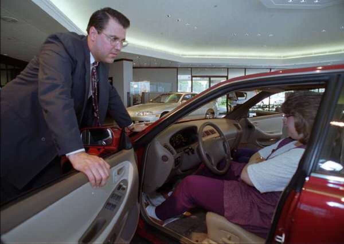 A car shopper sits in a Lexus in a dealership in Plano, Texas. Lexus helped pioneer the popularity of certified pre-owned cars. Now such cars make up 21% of all used cars sales.