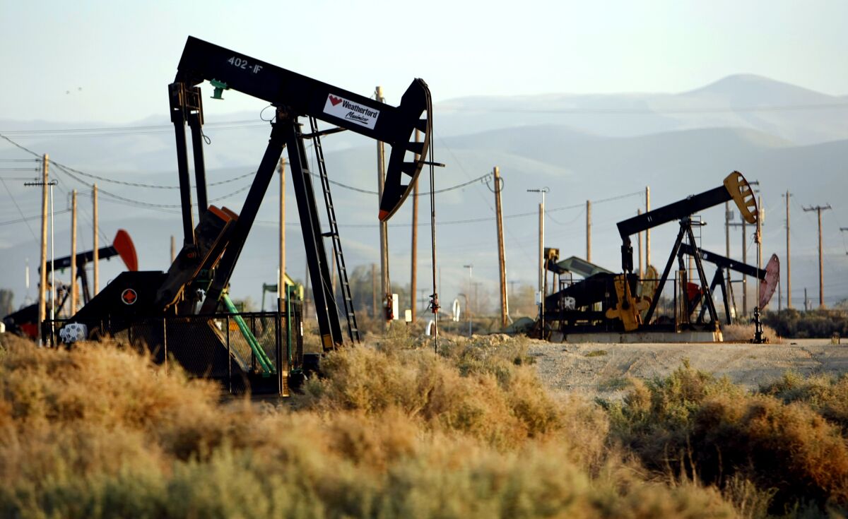 Pumpjacks work an oil field.
