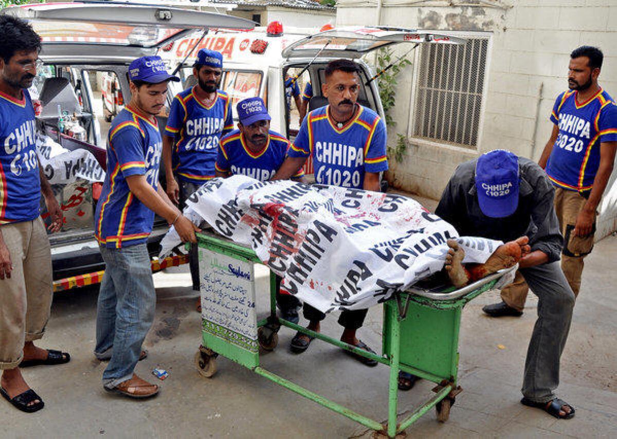 Pakistani volunteers transfer the bodies of slain kidnappers to a hospital in Karachi. Police raided a kidnapping gang's hide-out and rescued a teenage boy being held for half a million dollars in ransom. The raid left four kidnappers dead; a fifth suspect was arrested.
