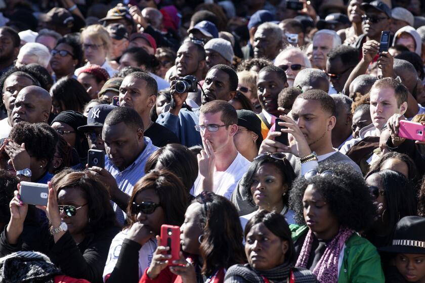 The crowd listens as President Obama speaks at the foot of the Edmund Pettus Bridge in Selma, Ala., to mark the 50th anniversary of the "Bloody Sunday" march for voting rights.
