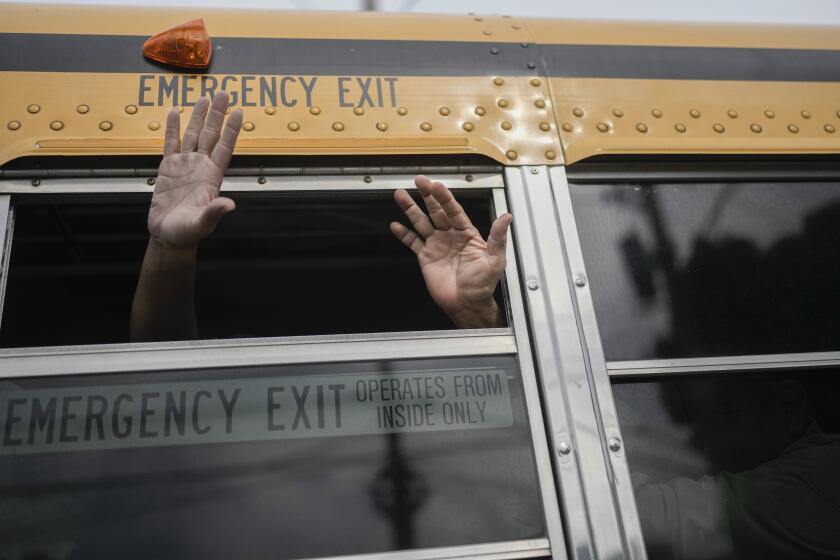 Nicaraguan citizens wave from a bus after being released from a Nicaraguan jail and landing at the airport in Guatemala City, Thursday, Sept. 5, 2024. (AP Photo/Moises Castillo)