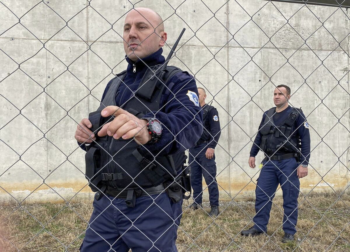 Kosovo prison guards inspect the fence of the 300-cell prison in Gjilan, 50 kilometers south east of the capital Pristina, Kosovo where Denmark's would run the new 300-cell facility, on Friday, Dec. 17, 2021. Kosovo's Justice Ministry said on Thursday that it has struck a preliminary agreement to rent 300 prison cells to Denmark, to help the Scandinavian country cope with its over-populated prison system. (AP Photo/str)