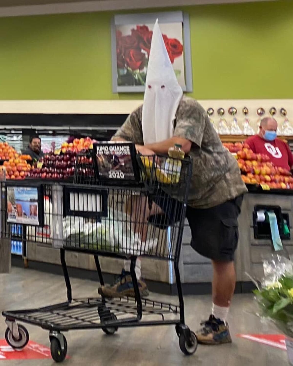 Man wearing a KKK hood in grocery store