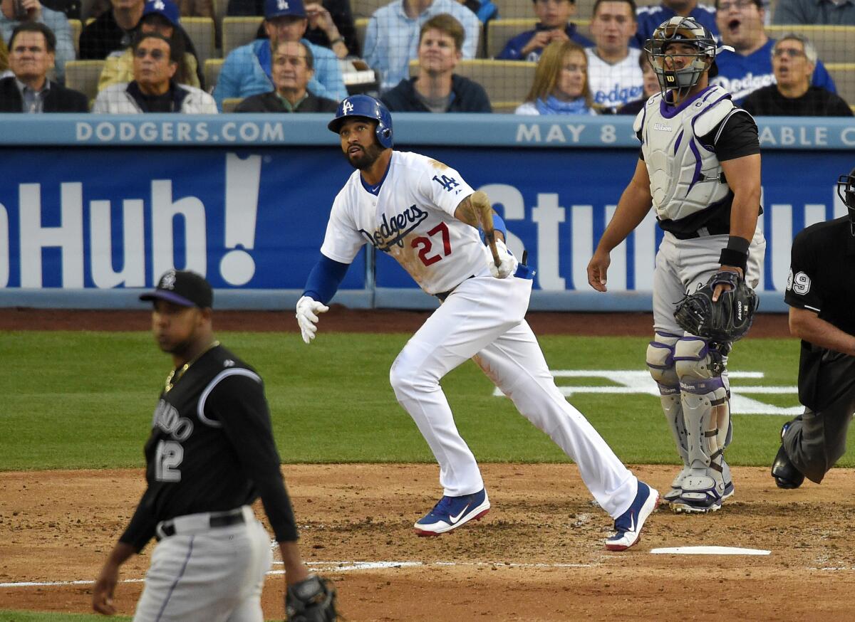 Matt Kemp, center, watches the solo home run he hit off Colorado pitcher Juan Nicasio during the third inning of the Dodgers' game against Colorado on Saturday night.