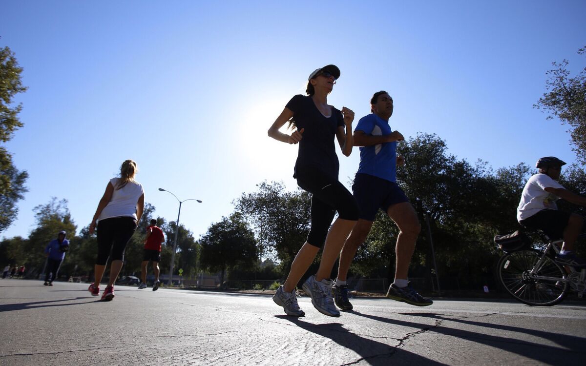 People running around the Pasadena Rose Bowl Friday morning as temperatures are expected to rise into the triple digits this weekend.