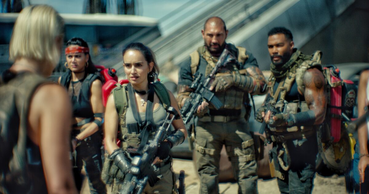 three women and two men dressed as armed mercenaries