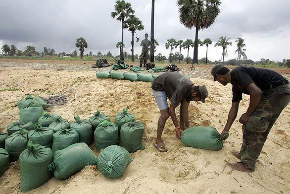 Sri Lankan soldiers build sand bunkers in the formerly rebel-held town of Mullaittivu in late January.