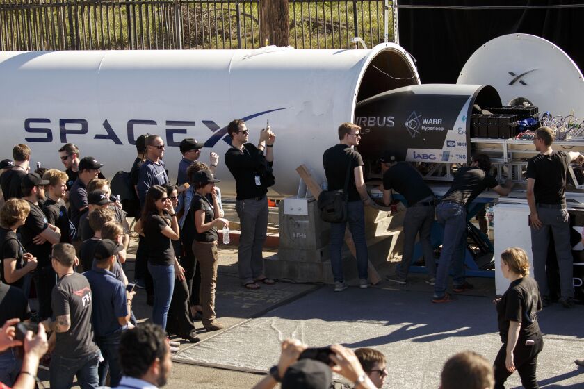 The WARR Hyperloop team from the Technical University of Munich, Germany, loads their magnetic levitation pod during the Hyperloop Pod Competition by SpaceX on Sunday, January 29, 2017 in Hawthorne, Calif. Students from colleges and universities worldwide competed to test their pods on a Hyperloop track that runs 1.25 kilometers down Jack Northrop Ave. between Crenshaw Blvd. and Prairie Ave. (Patrick T. Fallon/ For The Los Angeles Times)