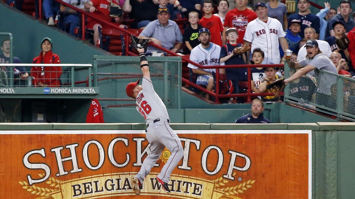 Angels right fielder Kole Calhoun makes a leaping catch on a ball hit by Boston's Brock Holt during the second inning of the Angels' 4-3 victory Tuesday.