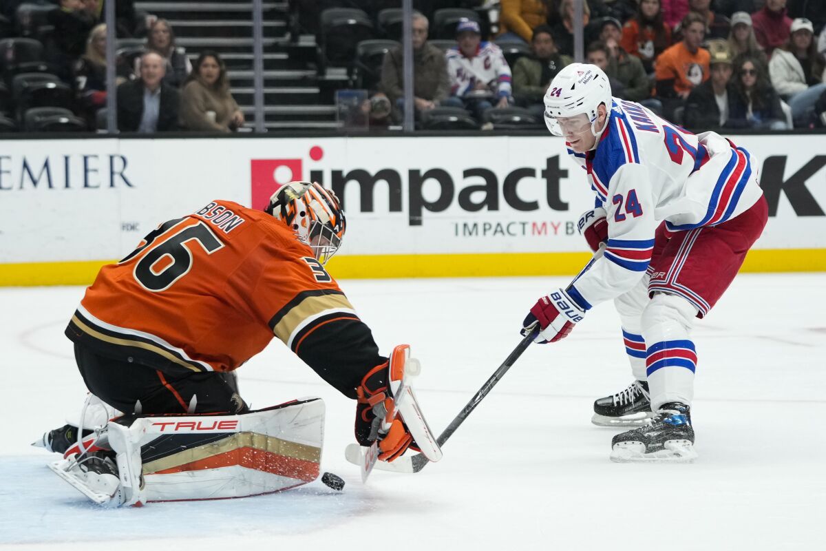 Ducks goaltender John Gibson makes a save against New York Rangers' Kaapo Kakko.