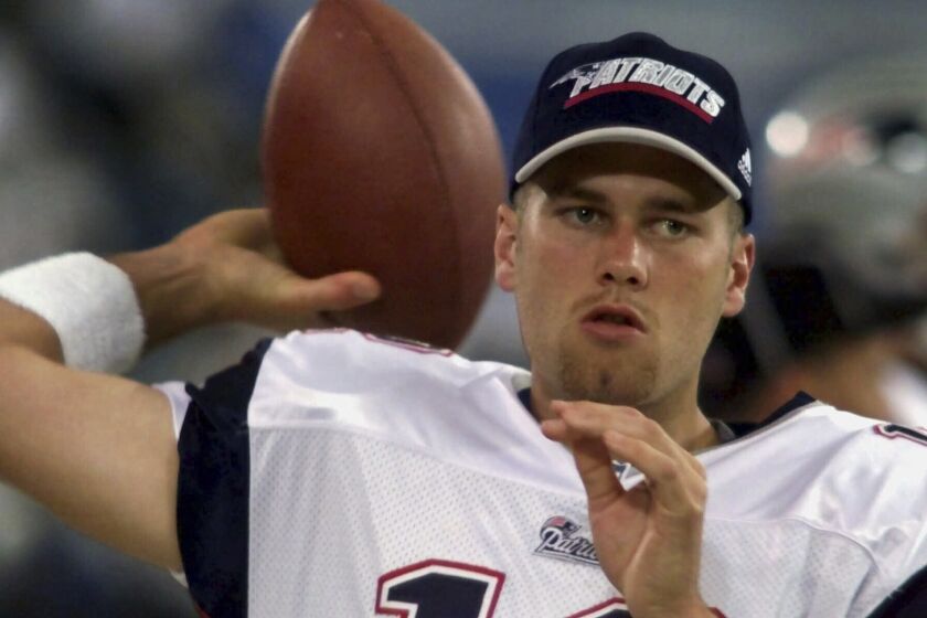FILE - New England Patriots backup quarterback Tom Brady warms up on the sidelines before the game against the Detroit Lions at the Silverdome in Pontiac, Mich., Friday, Aug. 4, 2000. Brady, who won a record seven Super Bowls for New England and Tampa, has announced his retirement, Wednesday, Feb. 1, 2023. (AP Photo/Carlos Osorio, File)
