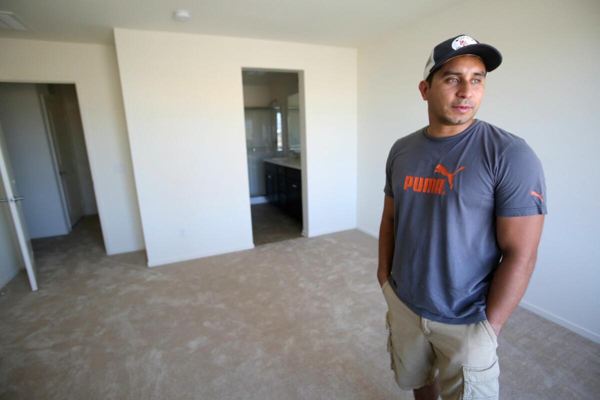Sergio Florez inside the new master bedroom of his new condo in Otay Mesa Saturday. photo by Bill Wechter.