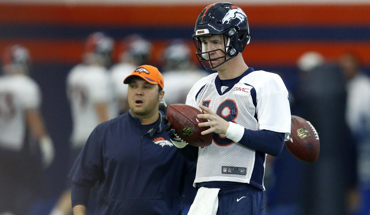 Denver Broncos quarterback Peyton Manning warms up during practice at the team's headquarters on Wednesday.