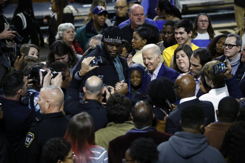 Joe Biden and attendees at a campaign rally. 