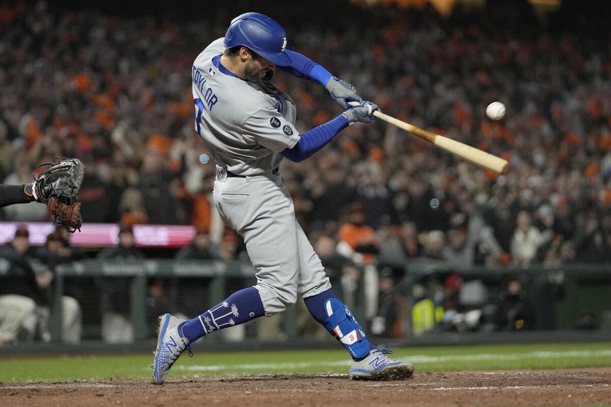 Los Angeles Dodgers' Chris Taylor hits an RBI single against the San Francisco Giants.