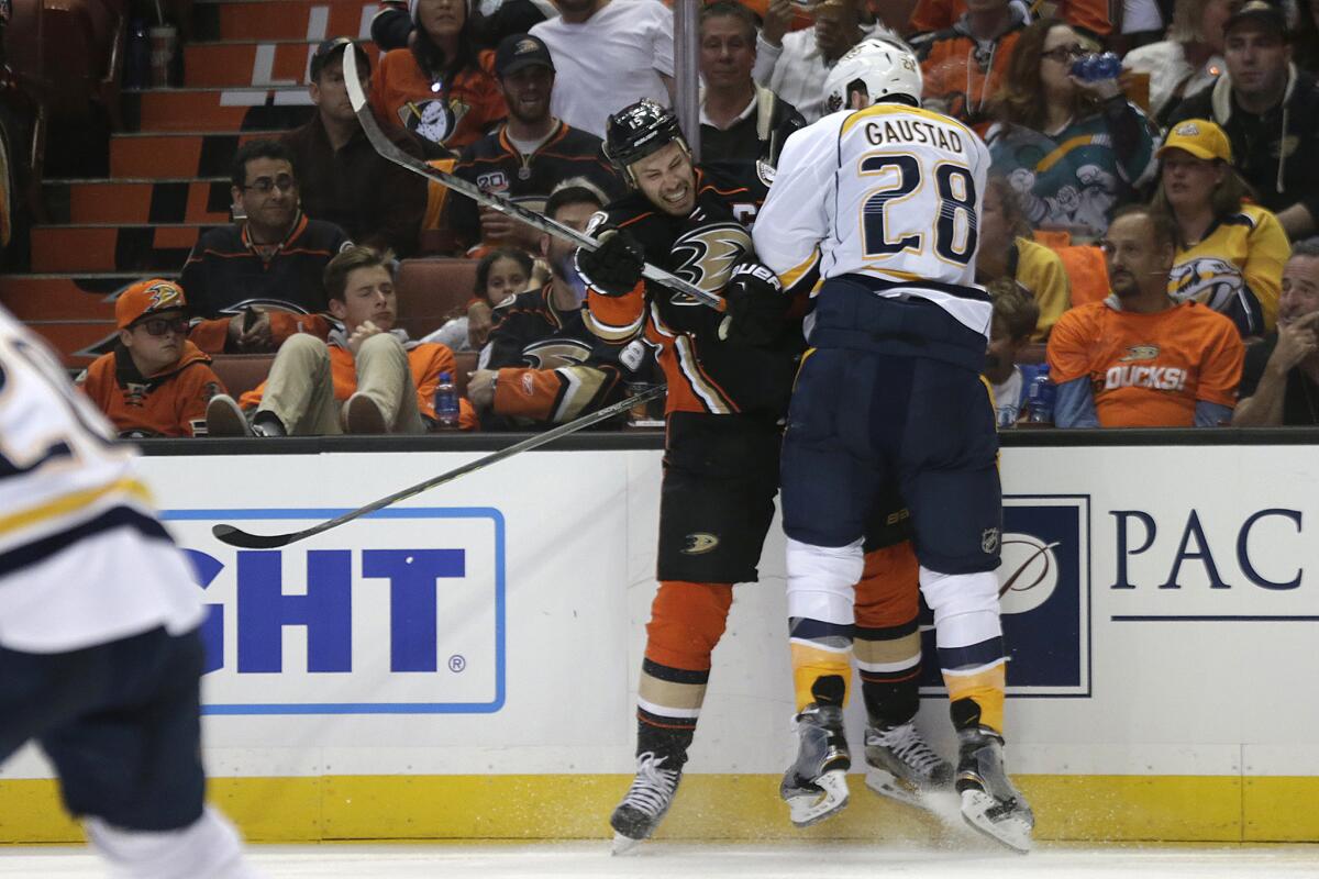 Ducks center Ryan Getzlaf absorbs a hard check from Predators forward Paul Gaustad during the second period.