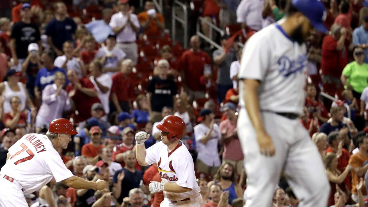 Cardinals third baseman Jedd Gyorko is congratulated by third base coach Chris Maloney after hitting a solo home run off Dodgers reliever Kenley Jansen during the ninth inning.