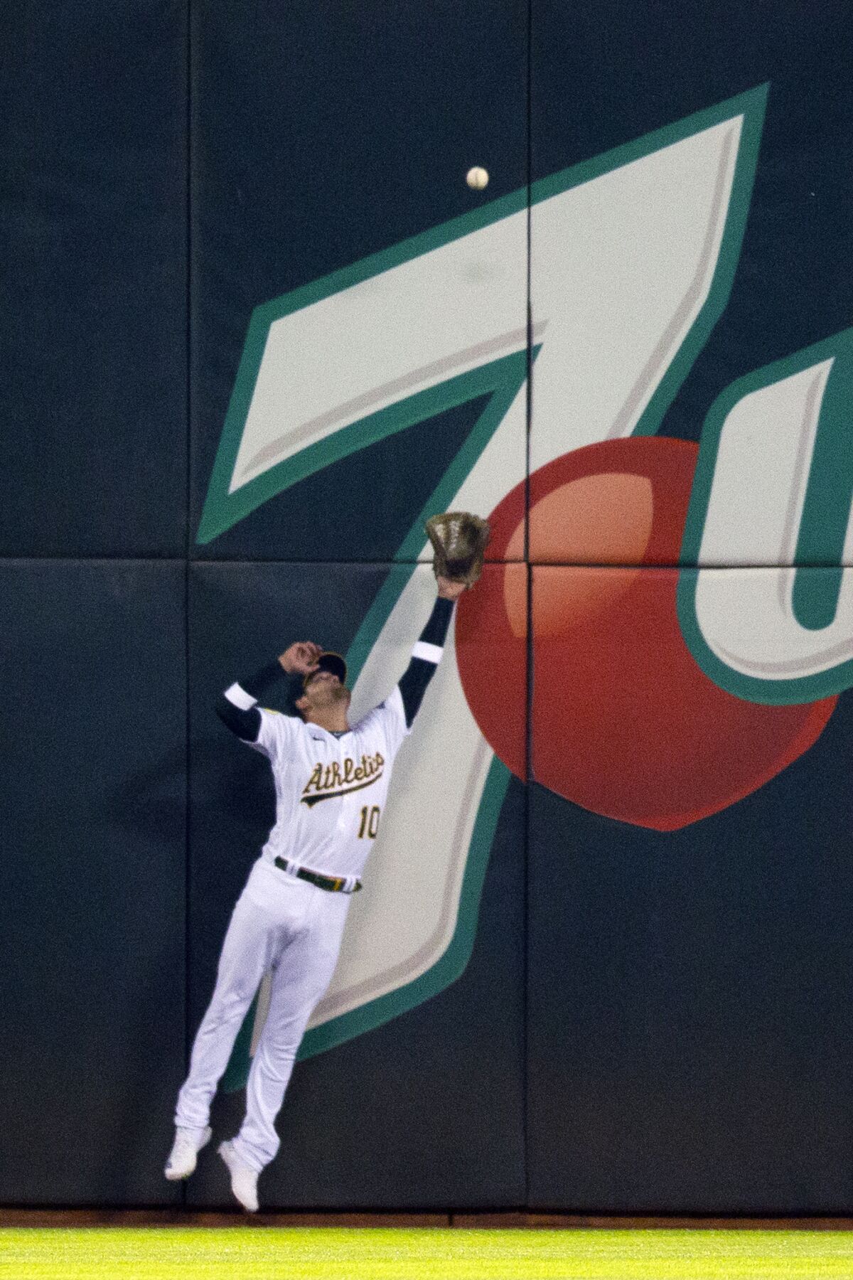 Oakland Athletics left fielder Chad Pinder makes a leaping catch at the wall on a ball hit by Kansas City Royals' Bobby Witt Jr. during the sixth inning of a baseball game Friday, June 17, 2022, in Oakland, Calif. (AP Photo/D. Ross Cameron)
