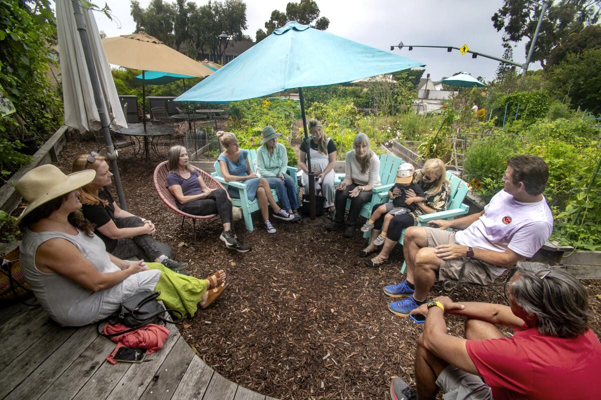 Local gardeners and residents hold a meeting at the South Laguna Community Garden Park on Thursday.