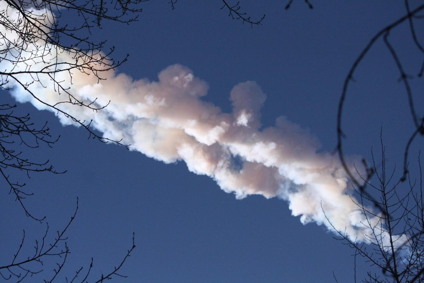 A meteor is seen in the sky over the city of Chelyabinsk