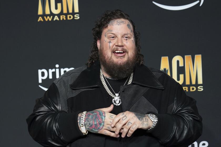 Musician Jelly Roll smiles while arriving at an awards show