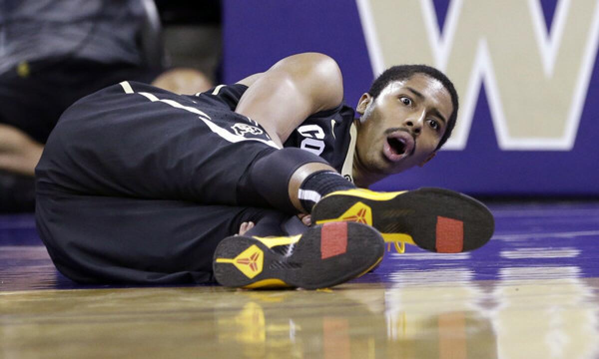 Colorado's Spencer Dinwiddie looks up after suffering an injury during the first half of Sunday's game against Washington. Dinwiddie suffered a torn anterior cruciate ligament and is out for the rest of the season.