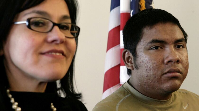 Gregorio Perez Cruz, right, and his attorney Noemi Ramirez shown in 2009. In a ruling Thursday, a federal appeals court revoked his deportation after determining that immigration agents violated the law in a 2008 raid.