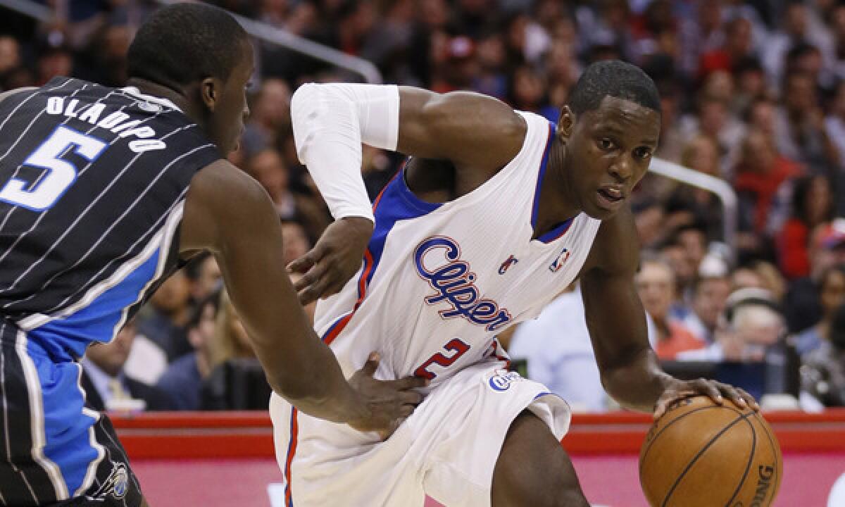Clippers point guard Darren Collison, right, drives around Orlando's Victor Oladipo during a Jan. 6 win. An injury to his left big toe hampered Collison against the Detroit Pistons on Monday.