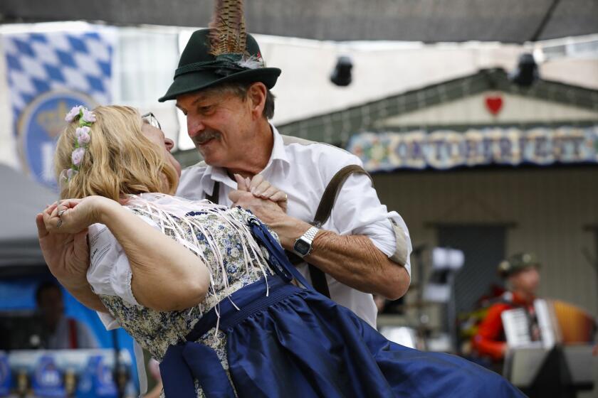 John Rollins (right) finishes a German folk dance with his wife, Susan.