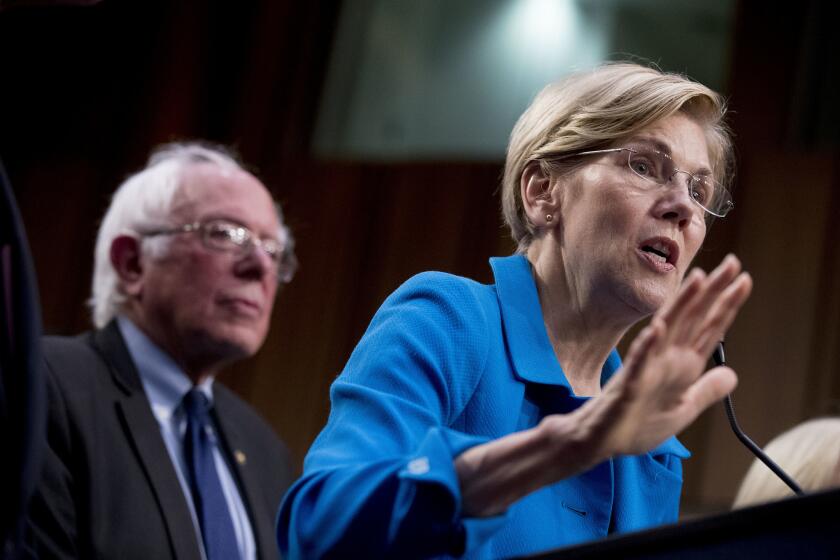 Sen. Elizabeth Warren, D-Mass., right, accompanied by Sen. Bernie Sanders, I-Vt., left, speaks during a news conference on Capitol Hill in Washington, Wednesday, Sept. 13, 2017, to unveil their Medicare for All legislation to reform health care. (AP Photo/Andrew Harnik)