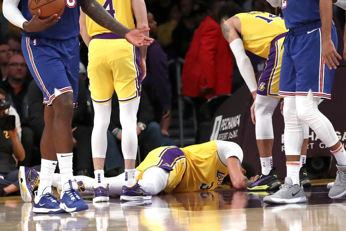 LOS ANGELES, CALIFORNIA - JANUARY 07: Anthony Davis #3 of the Los Angeles Lakers lays on the ground after being injured in a collision while defending Julius Randle #30 of the New York Knicks during the second half of a game at Staples Center on January 07, 2020 in Los Angeles, California. NOTE TO USER: User expressly acknowledges and agrees that, by downloading and/or using this photograph, user is consenting to the terms and conditions of the Getty Images License Agreement (Photo by Sean M. Haffey/Getty Images) ** OUTS - ELSENT, FPG, CM - OUTS * NM, PH, VA if sourced by CT, LA or MoD **