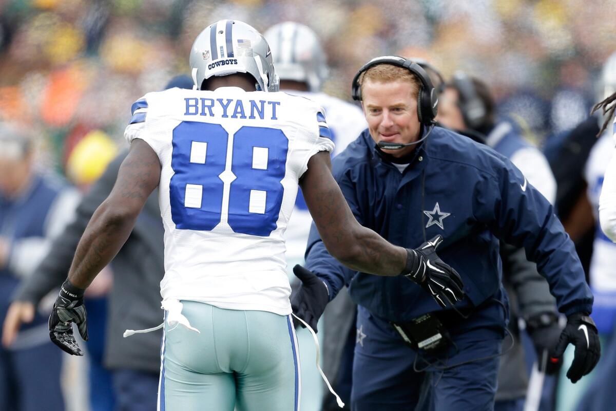 Dallas Cowboys Coach Jason Garrett and receiver Dez Bryant, right, celebrate after a touchdown against the Green Bay Packers in divisional playoff game on Jan. 11. The Packers beat the Cowboys, 26-21.