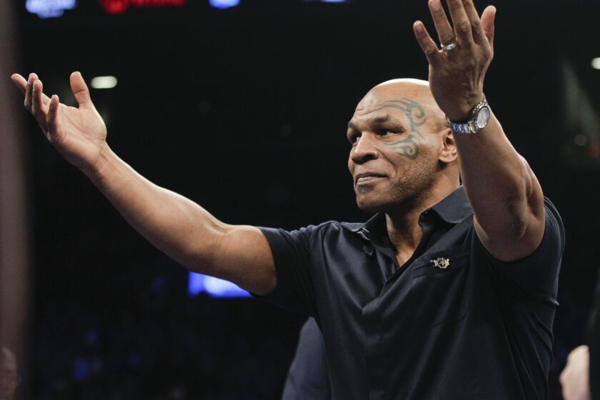Former boxer Mike Tyson acknowledges the crowd before a WBC heavyweight title boxing match between Deontay Wilder and Artur Szpilka in New York on Jan. 16.