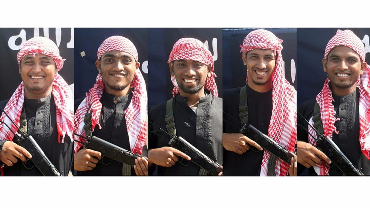 This combination of pictures shows five unidentified men, allegedly the gunmen who carried out an attack in the capital Dhaka on Friday, posing in front of an Islamic State flag.