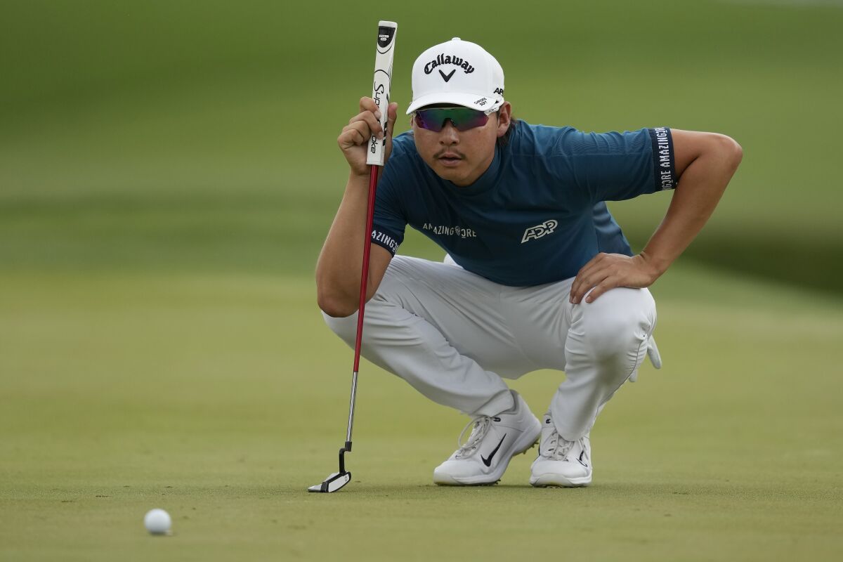 Min Woo Lee lines his putt on the ninth green during the final round of The Players Championship golf tournament, Sunday, March 12, 2023, in Ponte Vedra Beach, Fla. (AP Photo/Charlie Neibergall)