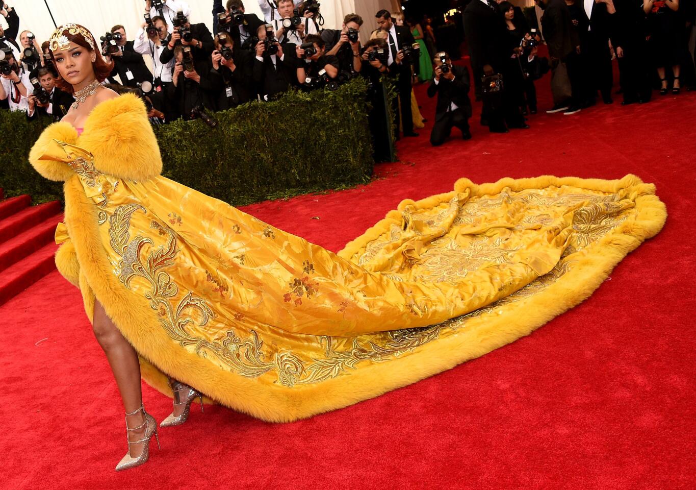 At the 2015 Met Gala, Rihanna's elaborate cape, made by Chinese designer Guo Pei, was so sweepingly huge that it required several train-handlers to help her down the red carpet.