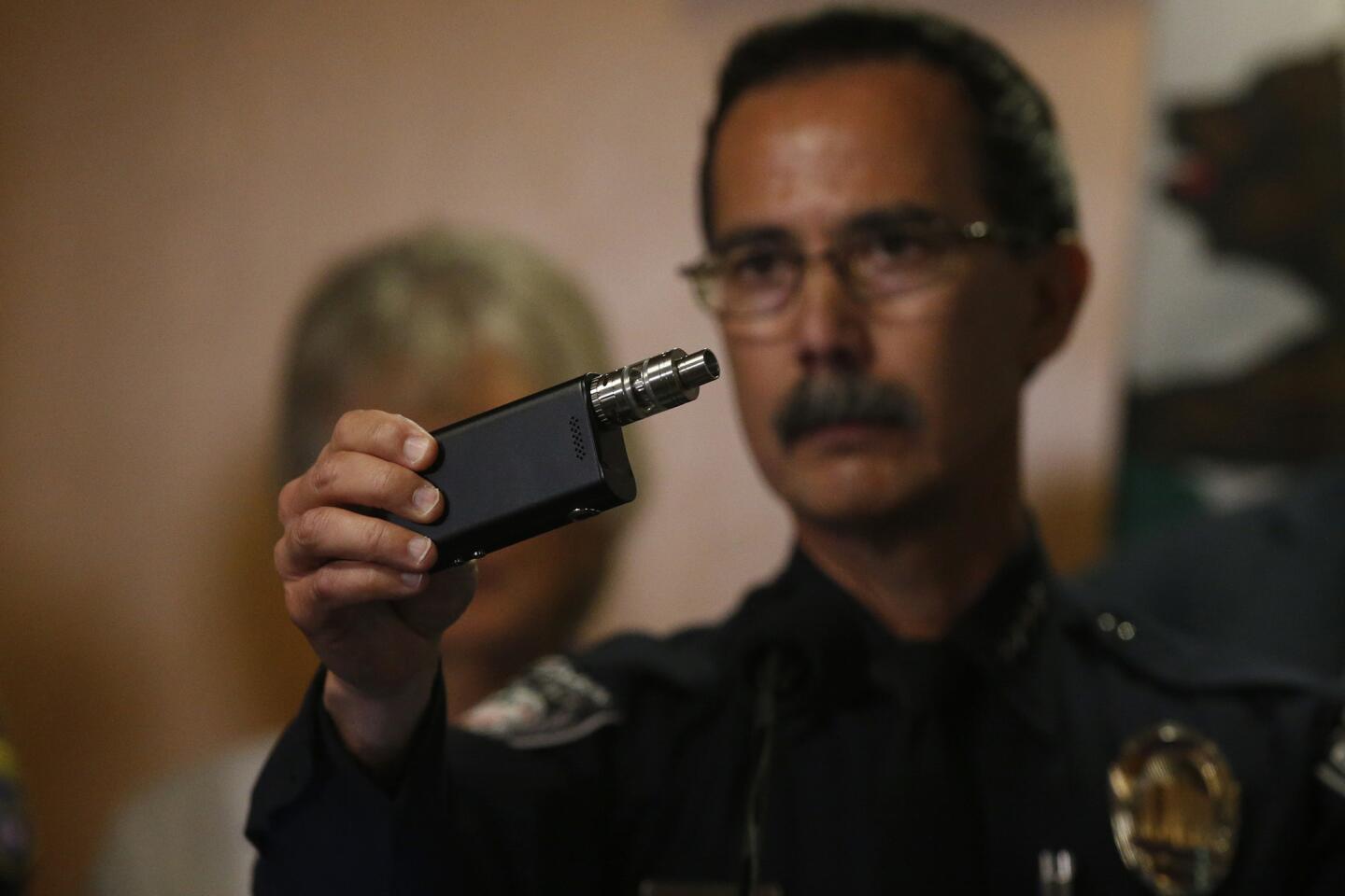 El Cajon Police Chief Jeff Davis holds a vaping device similar to the one that victim Alfred Olango was holding in the video.