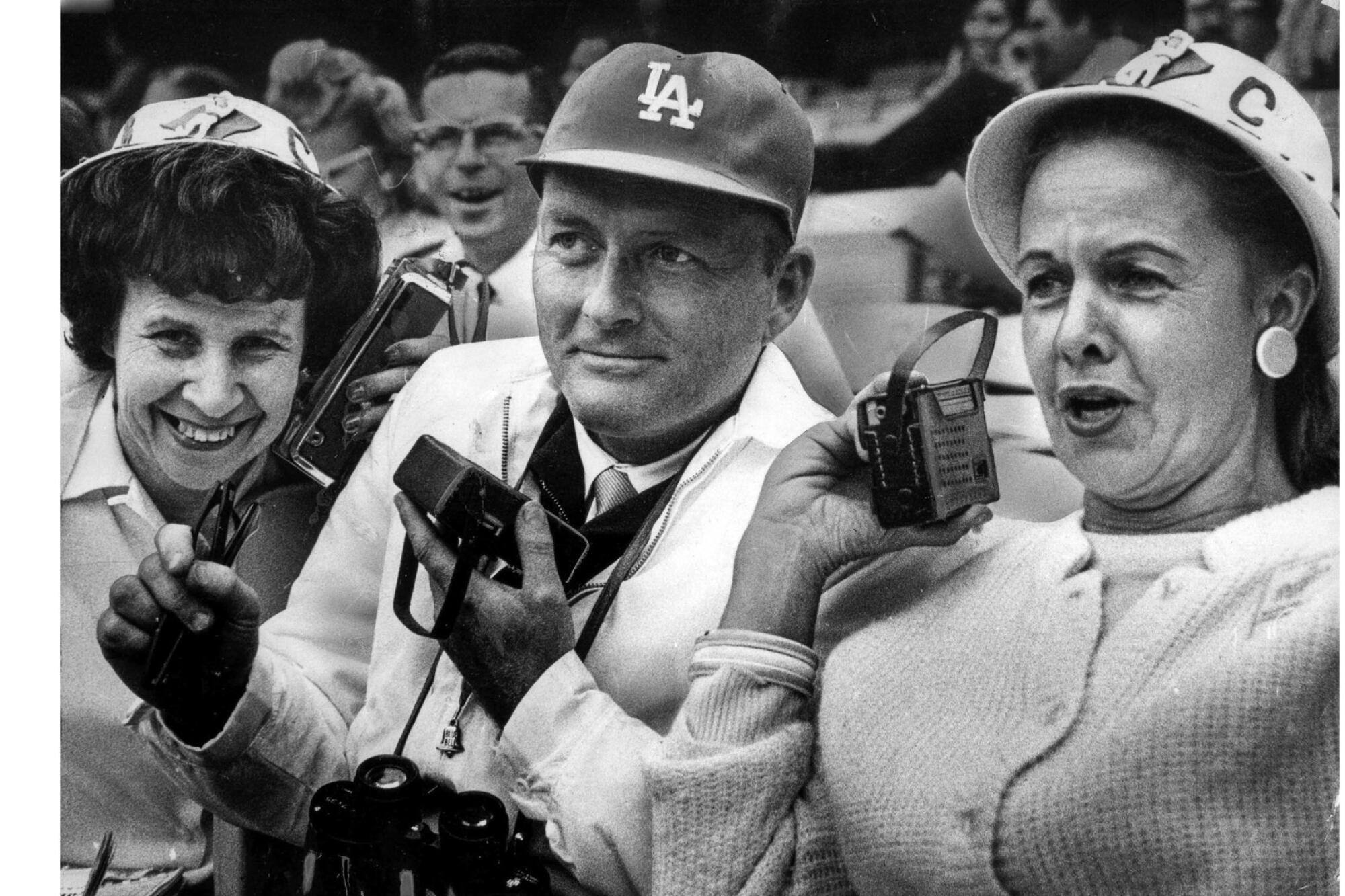 Dodgers booster club members listen to Vin Scully on the radio during a game.
