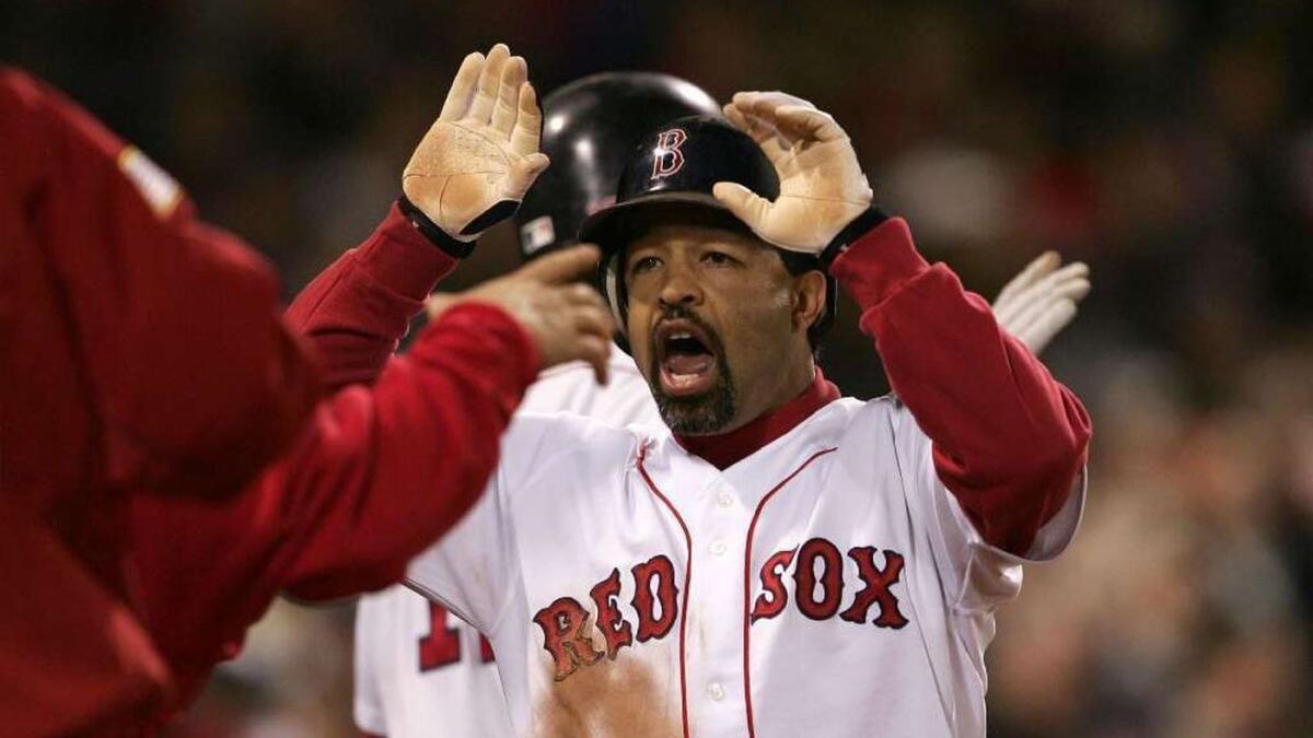 Dave Roberts celebrates with his Red Sox teammates after scoring on a game-tying sacrifice fly in Game 5 of the 2004 ALCS.