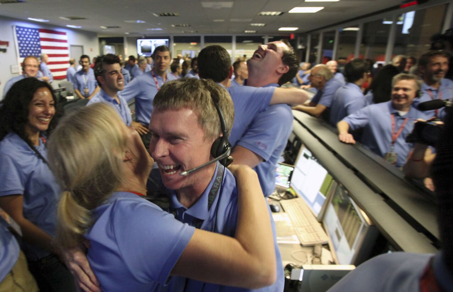NASA employees express joy after establishing connection with Curiosity on Mars.