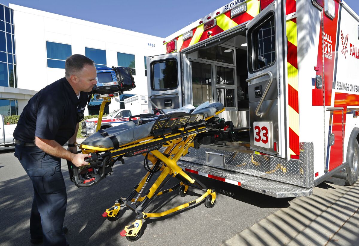 EMT Patrick Hillman loads a gurney into a new Falck ambulance in Kearney Mesa Wednesday. 