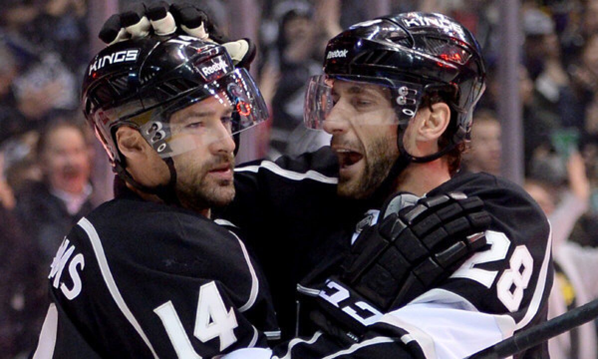 Kings forward Justin Williams, left, celebrates with teammate Jarret Stoll after scoring a goal against the Boston Bruins on Jan. 9. The Kings will be looking to secure a favorable playoff spot over the final 23 games of the regular season.
