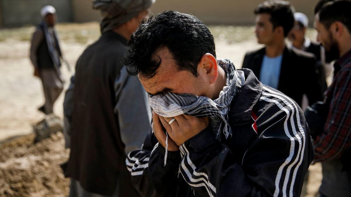 Shira Ahmad weeps at the funeral of his father, Karbalai Mohammad Anwar Noori, who was among at least 50 people killed in a suicide bomb attack on a Shiite mosque in Kabul on Oct. 20, 2017.