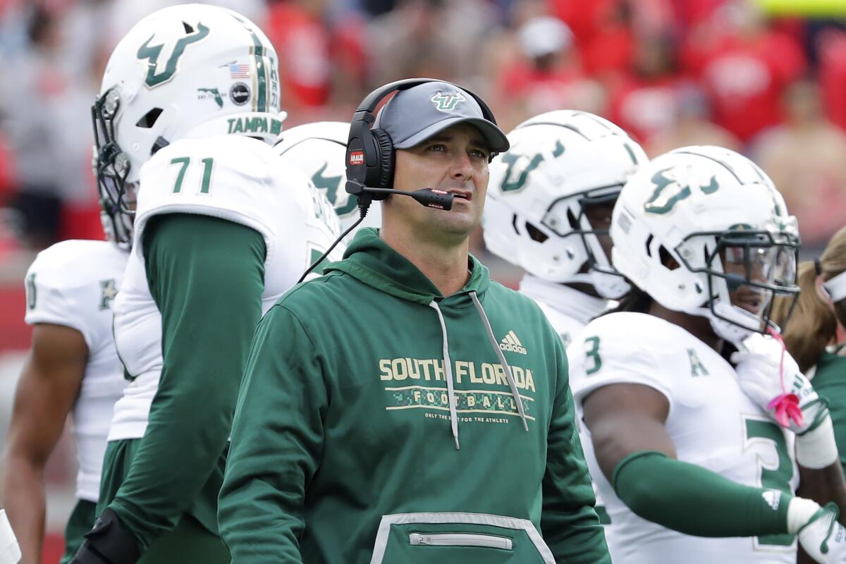 South Florida head coach Jeff Scott checks the scoreboard during a timeout in the first half of an NCAA college football game against Houston, Saturday, Oct. 29, 2022, in Houston. (AP Photo/Michael Wyke)
