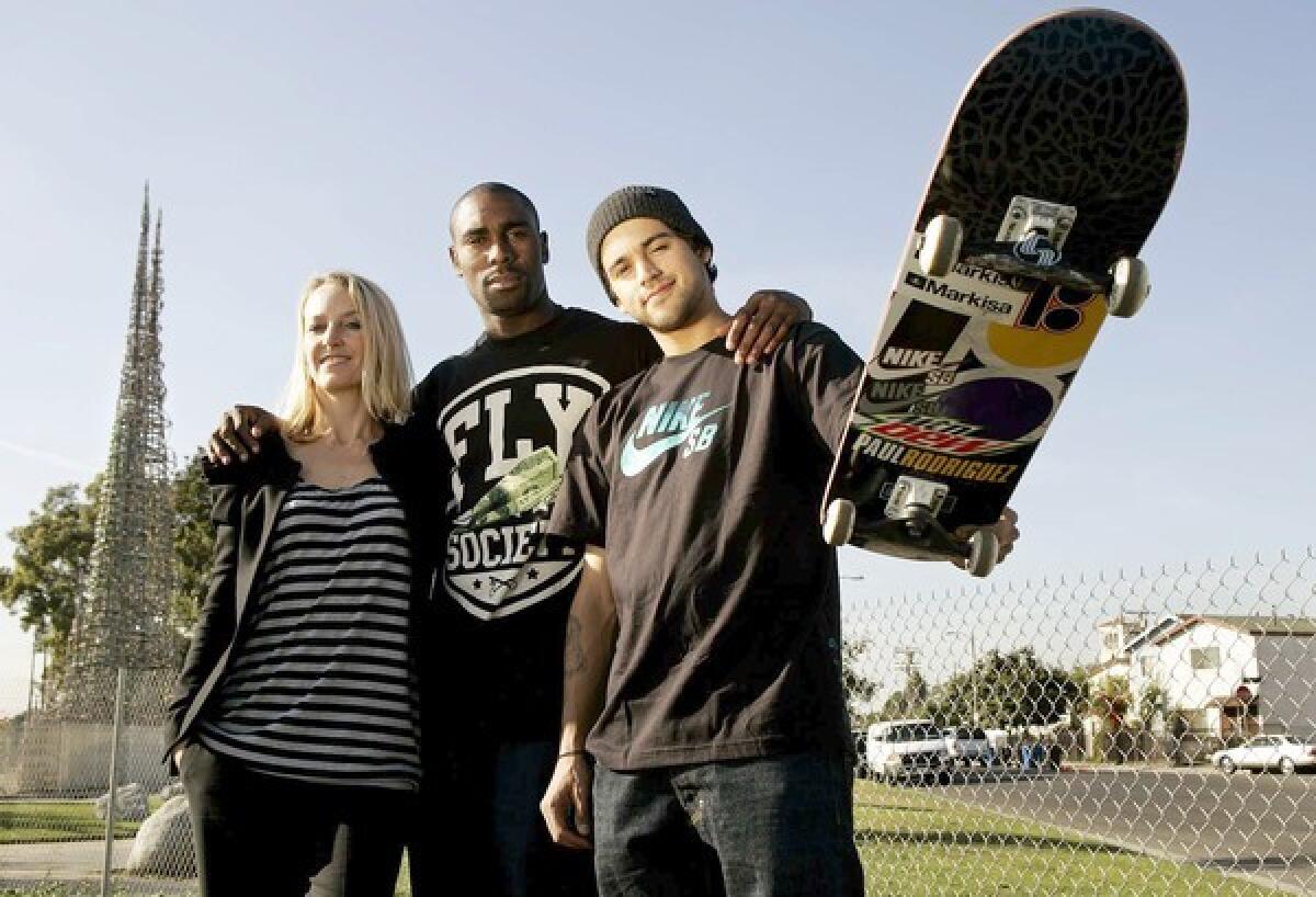 Circe Wallace of Wasserman Media Group, left, and pro skaters Terry Kennedy and Paul Rodriguez on vacant land near the towers.