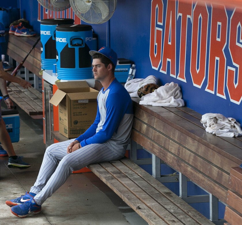 Florida's Tommy Mace (47) sits in the dugout following to the Gators 19-1 loss to South Alabama in an NCAA regional tournament college baseball game against South Alabama at Florida Ballpark, Saturday, June 5, 2021, in Gainesville, Fla. (Cyndi Chambers/Ocala Star-Banner via AP)